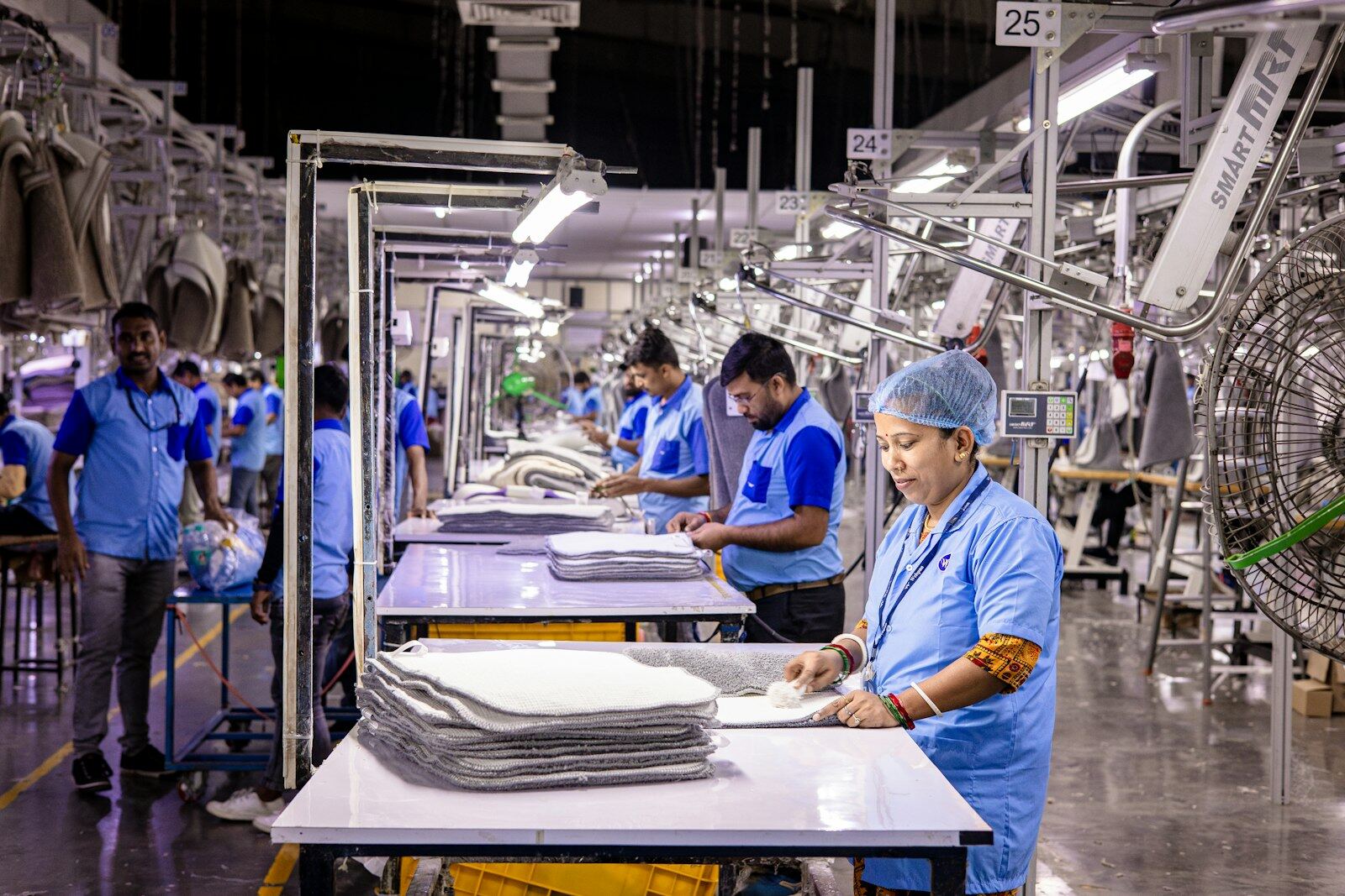 Workers at inspection tables on a garment factory floor